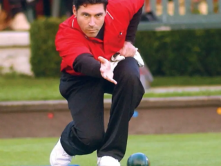 Lawn bowling, with roots in ancient Egypt and Rome, is a sport that involves rolling biased balls (called bowls) towards a smaller target ball (called the jack) on a flat, carefully manicured grass surface